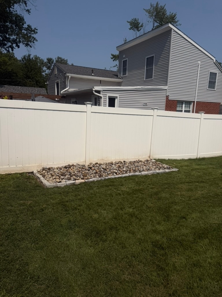 Raised river rock bed with Belgian block border in Wallingford, PA