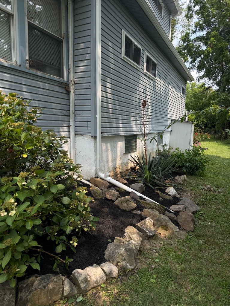 Freshly mulched planting bed with stone border in Ridley, PA