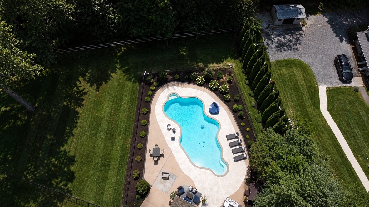 Aerial view of mulched planting beds surrounding a backyard pool in West Chester, PA