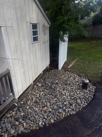 River rock bed installed along a shed foundation in Newtown Square, PA